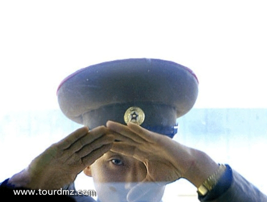 North Korean soldiers watch the tourists